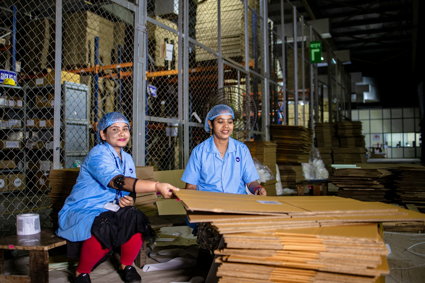 Two workers preparing cardboard packaging